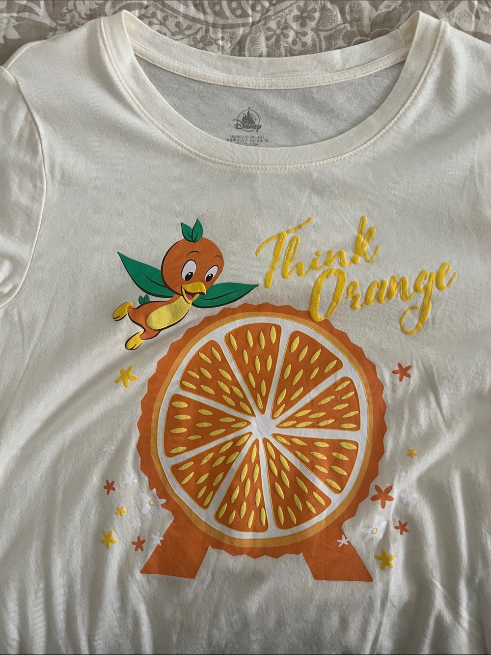 Disney cream tunic-style tee with orange slice Epcot graphic and Orange Bird